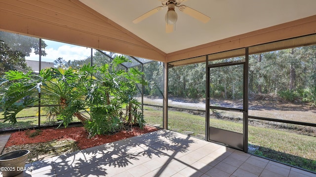 unfurnished sunroom featuring ceiling fan and vaulted ceiling