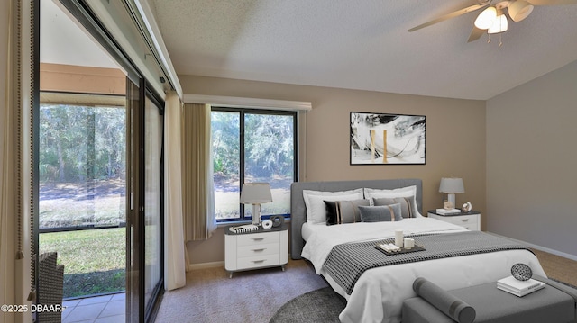 carpeted bedroom with a ceiling fan, baseboards, and a textured ceiling