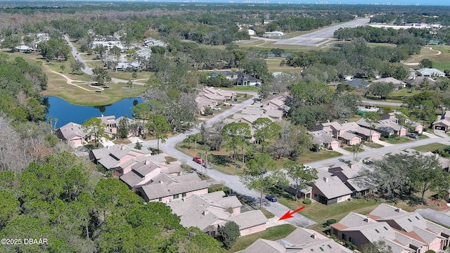 drone / aerial view with a residential view and a water view