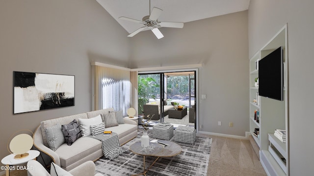 living room featuring high vaulted ceiling, carpet floors, baseboards, built in shelves, and ceiling fan