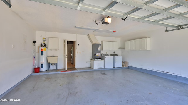 garage featuring washing machine and clothes dryer, baseboards, a garage door opener, and electric water heater