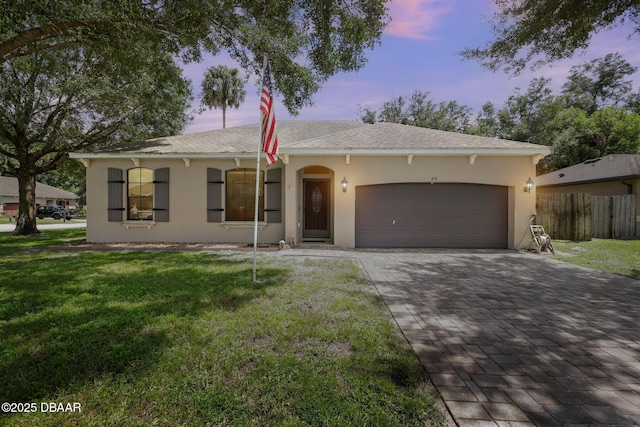 single story home with a lawn and a garage