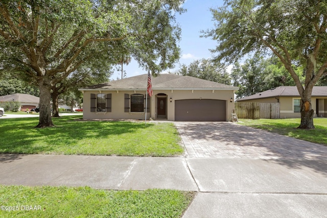 single story home featuring a garage and a front yard