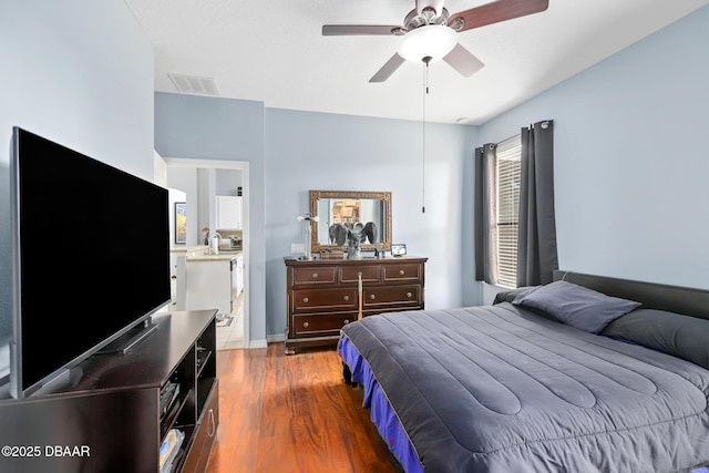 bedroom with ceiling fan and dark hardwood / wood-style flooring