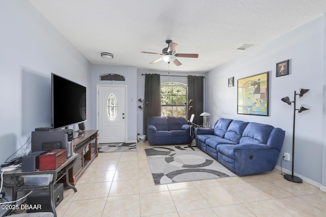 tiled living room with a textured ceiling and ceiling fan