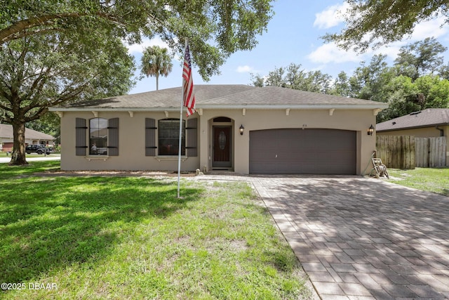 single story home featuring a front yard and a garage