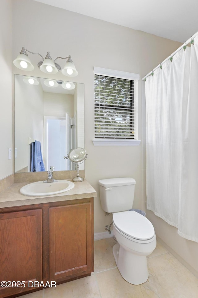 full bathroom featuring toilet, vanity, tile patterned floors, and shower / tub combo with curtain