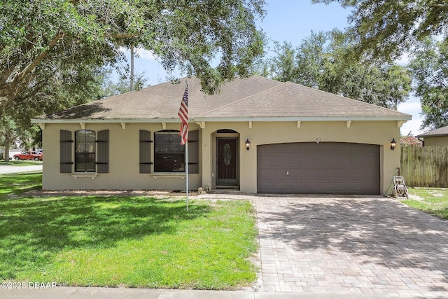 ranch-style house with a garage and a front yard