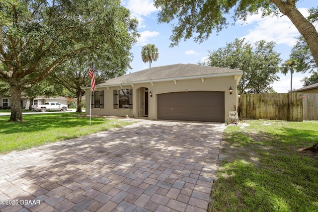 view of front of home featuring a garage and a front lawn