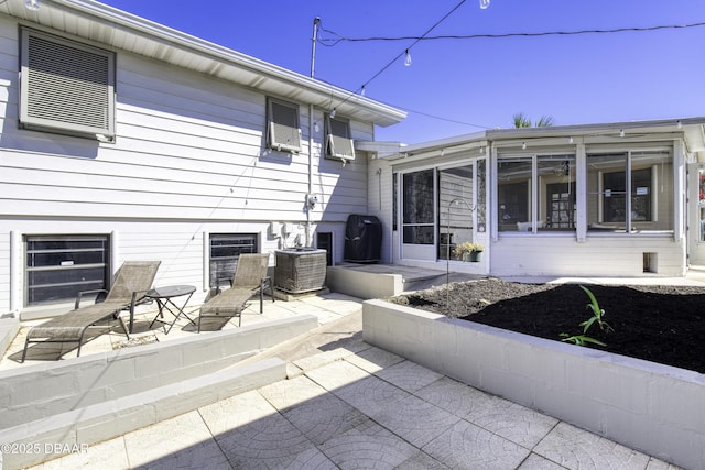 back of property featuring a patio area, cooling unit, and a sunroom