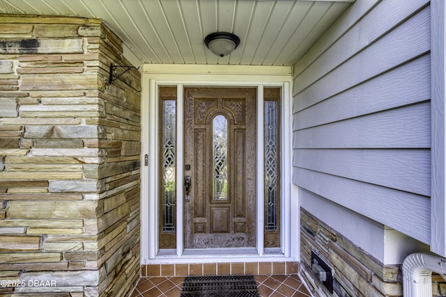 property entrance with stone siding