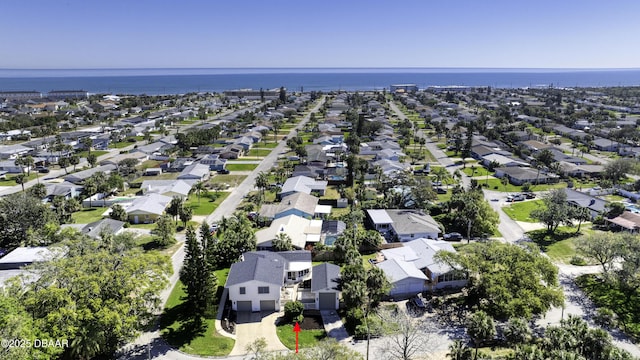 birds eye view of property featuring a water view and a residential view