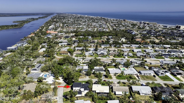 drone / aerial view featuring a residential view and a water view