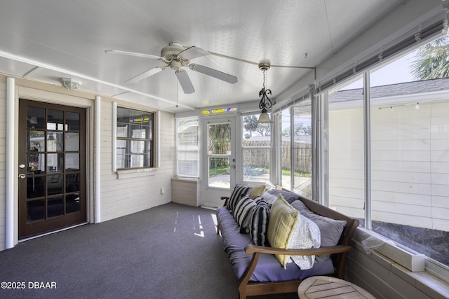 sunroom / solarium featuring a ceiling fan