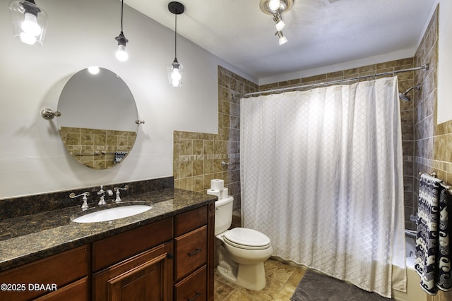 full bathroom with vanity, shower / tub combo, and toilet