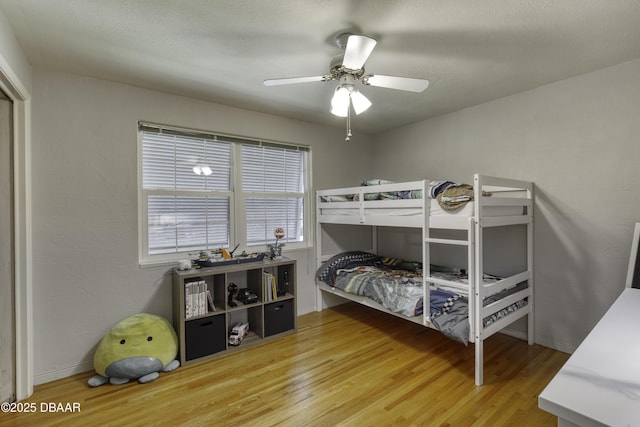 bedroom with ceiling fan and wood finished floors