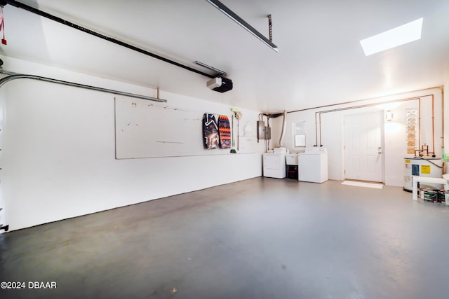 garage with separate washer and dryer and a garage door opener