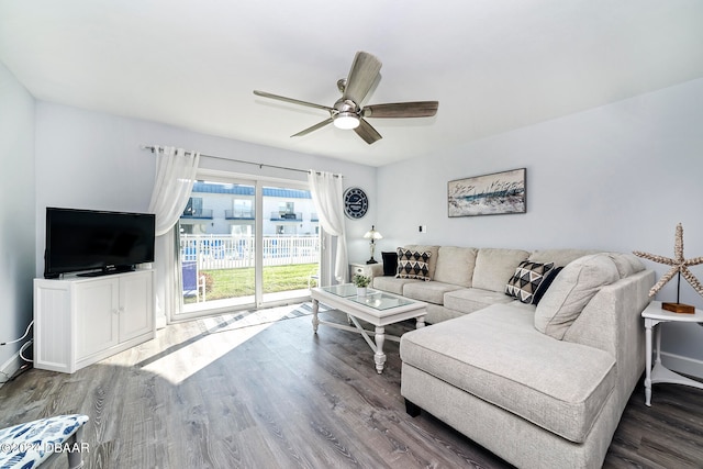 living room with hardwood / wood-style flooring and ceiling fan