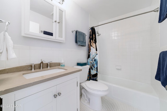 full bathroom featuring tile patterned flooring, shower / bathtub combination with curtain, vanity, toilet, and tile walls