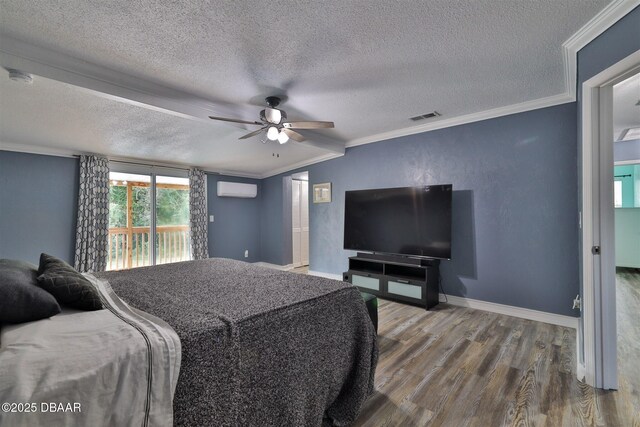 180 Willow Run, Ormond Beach, FL 32174 - bedroom with a wall mounted AC, crown molding, a textured ceiling, wood finished floors, and access to outside