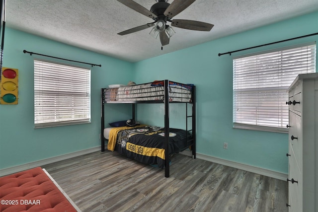 180 Willow Run, Ormond Beach, FL 32174 - bedroom with a textured ceiling, wood finished floors, baseboards, and a ceiling fan