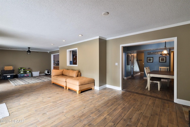 180 Willow Run, Ormond Beach, FL 32174 - living area with ornamental molding, wood finished floors, a textured ceiling, baseboards, and recessed lighting
