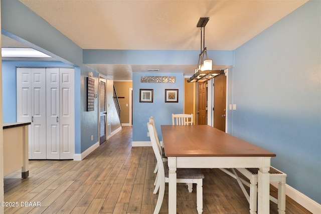 180 Willow Run, Ormond Beach, FL 32174 - dining area featuring baseboards, a chandelier, and wood finished floors