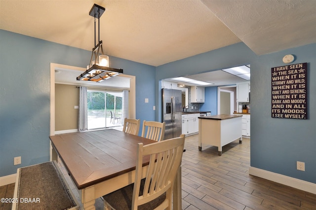 180 Willow Run, Ormond Beach, FL 32174 - dining area with baseboards, wood finished floors, and a textured ceiling