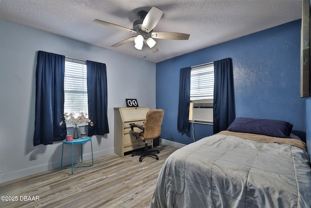 180 Willow Run, Ormond Beach, FL 32174 - bedroom featuring wood finished floors, a textured ceiling, baseboards, and a ceiling fan