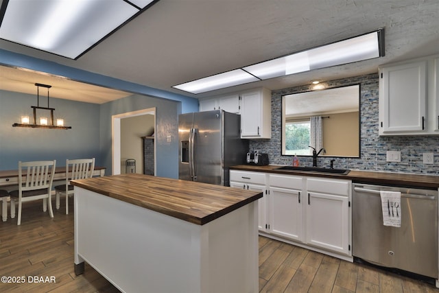 180 Willow Run, Ormond Beach, FL 32174 - kitchen with wood counters, a sink, stainless steel appliances, and backsplash