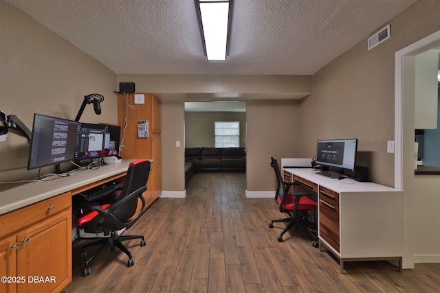 180 Willow Run, Ormond Beach, FL 32174 - home office with a textured ceiling, dark wood-type flooring, and baseboards
