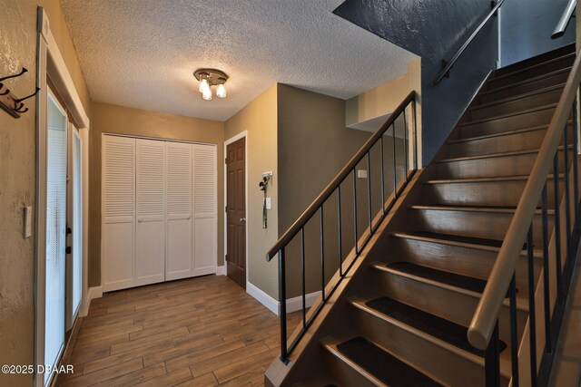 180 Willow Run, Ormond Beach, FL 32174 - foyer with wood finished floors, baseboards, stairs, and a textured ceiling