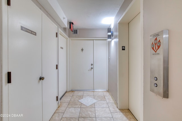 corridor featuring light tile patterned flooring