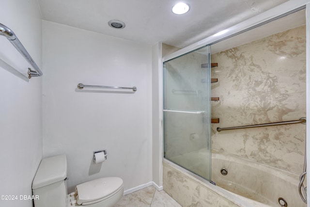 bathroom featuring tile patterned flooring, toilet, and bath / shower combo with glass door