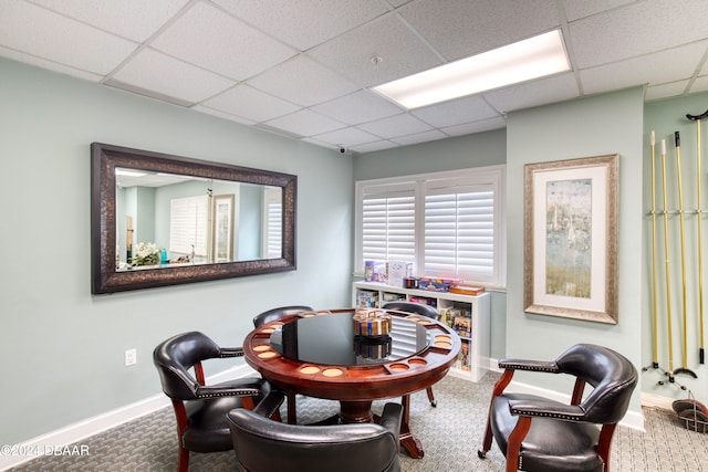 home office with carpet flooring and a paneled ceiling