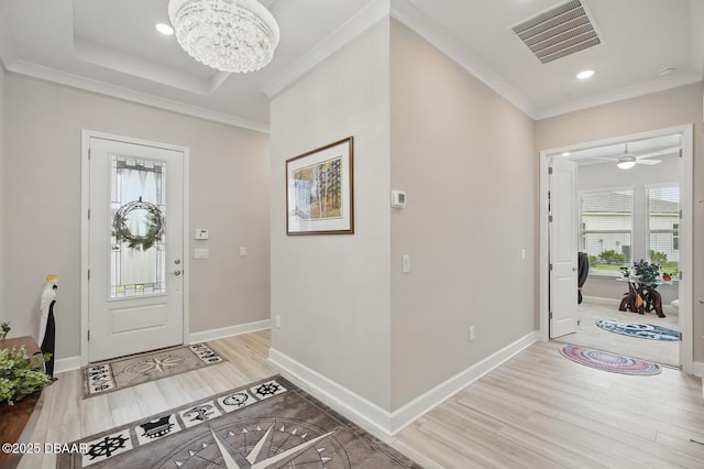 83 Reverie Dr N, Palm Coast, FL 32137 - foyer entrance with light wood-style floors, crown molding, a chandelier, baseboards, and a ceiling fan