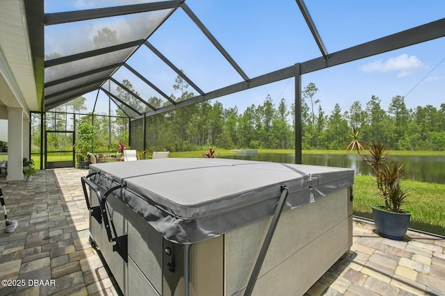 83 Reverie Dr N, Palm Coast, FL 32137 - view of patio / terrace with a hot tub, a water view, and glass enclosure