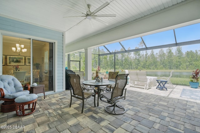 83 Reverie Dr N, Palm Coast, FL 32137 - sunroom with a water view, ceiling fan, a chandelier, and stone finish flooring