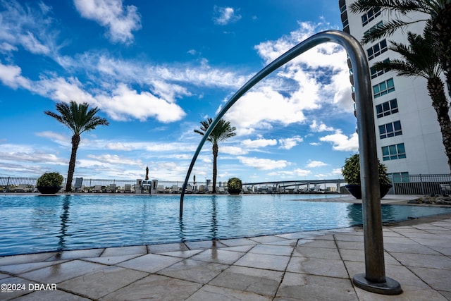 view of pool featuring a water view