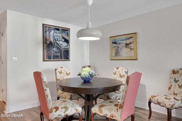 dining space with hardwood / wood-style floors