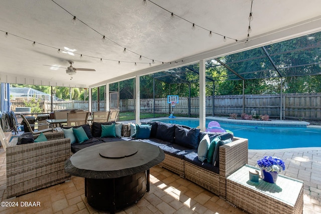 view of patio / terrace featuring an outdoor living space with a fire pit, a fenced in pool, and glass enclosure