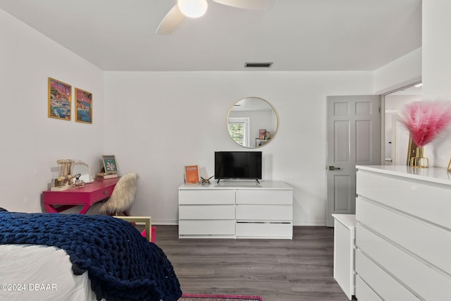 bedroom with dark hardwood / wood-style flooring and ceiling fan