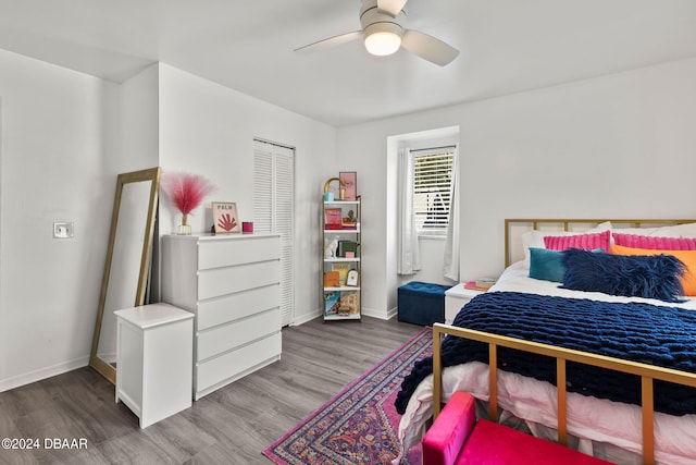 bedroom with ceiling fan, a closet, and light hardwood / wood-style flooring