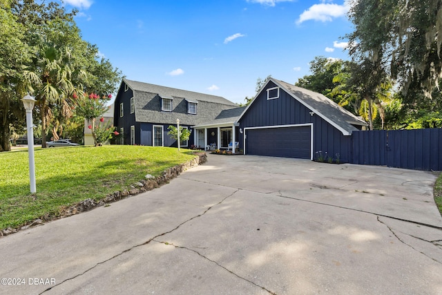 view of front of property featuring a front lawn and a garage