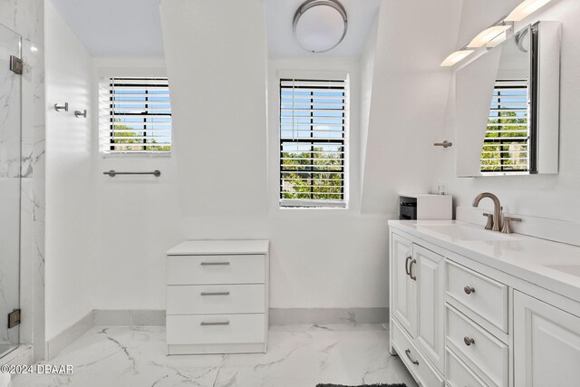 bathroom with vanity, a healthy amount of sunlight, and a shower with shower door