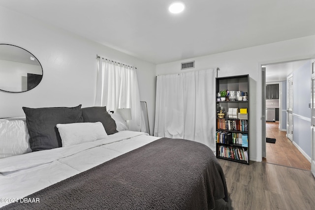 bedroom with hardwood / wood-style floors