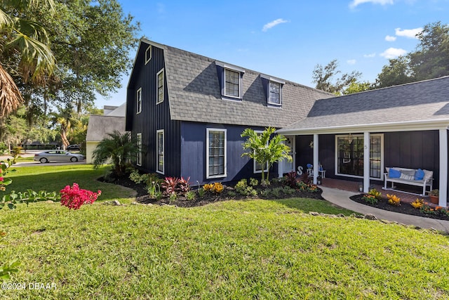 view of front of house featuring a front yard and an outdoor living space