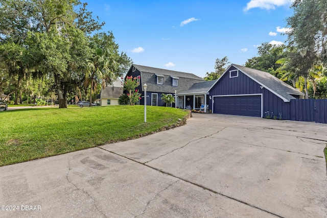 view of front of house with a garage and a front lawn