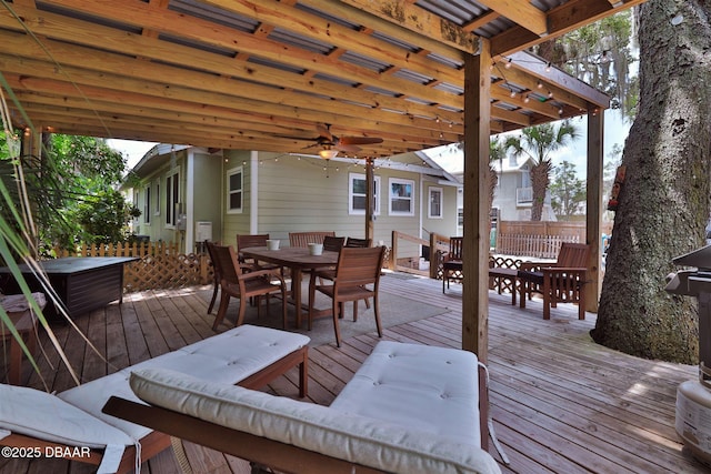 wooden deck with a pergola, outdoor dining area, and a ceiling fan