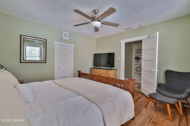 bedroom featuring visible vents, ceiling fan, and light wood-style floors